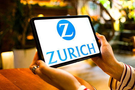In this photo illustration, the Zurich Insurance Group logo is seen displayed on a tablet screen.