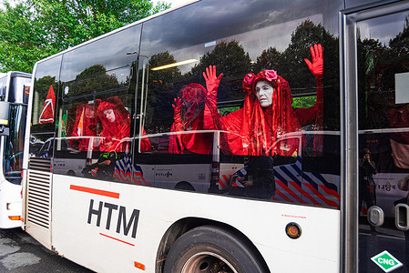 Arrested Extinction Rebellions’ Red Rebels, seen in the bus during the twenty-second-day of the A12 protest blockade. The police arrested 600 activists on Saturday who were partially blocking the A12 in The Hague. Extinction Rebellion demonstrations have now blocked the main entrance road to the A12 for twenty-two consecutive days, demanding the government stop supporting the fossil fuel industry. Police used water cannon against the protesters. The 600 demonstrators were taken by bus to the ADO football stadium and released without further action. The group threaten to repeat this action indefinably until their demands are met. XR were joined by more than a hundred German climate activists from the Letzte Generation group, they wore red jackets and sat separated from the main group, but still together. Letzte Generation is known in Germany for disruptive roadblocks, they recently defaced part of the Brandenburg Gate in Berlin. Members of the action group often glue themselves to the road surface, at times with a concrete mix, they are then removed by the authorities.