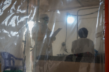 A doctor wearing full protective gear speaks to a patient in the Ebola treatment centre in Beni, eastern Democratic Republic of the Congo.
The DRC is currently experiencing the second worst Ebola outbreak in recorded history. More than 1,400 people have died.