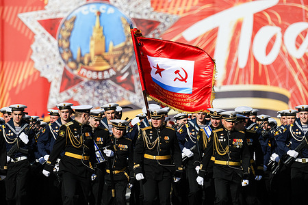 Naval personnel in dress uniforms march on Palace Square carrying the Ensign of the Russian Navy during a rehearsal for the military parade dedicated to the 81st anniversary of Victory in World War II. Troops rehearsed on Palace Square in St. Petersburg ahead of celebrations marking the 81st anniversary of Victory in the Great Patriotic War. Units from the Leningrad Military District, military cadets, and law enforcement representatives practiced marching drills accompanied by a combined military orchestra. The May 9 commemoration marks the surrender of Nazi Germany in 1945 and honors the residents of Leningrad who endured the wartime siege.