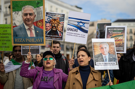 Iranian protesters hold placards and portraits of Reza Pahlavi, Crown Prince of Iran, during the demonstration. Iranian residents in Madrid gathered at the Puerta del Sol to celebrate the US and Israeli military intervention in Iran and the possible fall of the Islamic regime of the Ayatollahs.