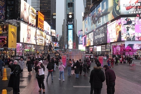 People walk through Times Square, Manhattan, New York City.