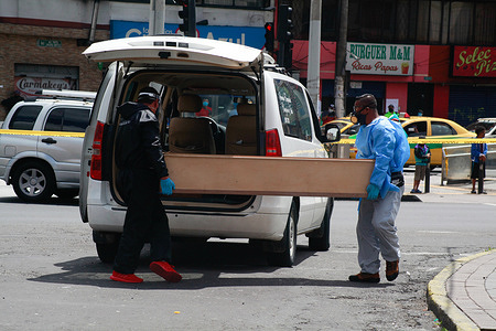 (EDITORS NOTE: Image depicts death)
Funeral staff members carry the body of a person suspected to have died due to the coronavirus disease (COVID-19) on the street.