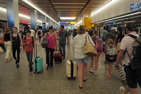 People are seen walking through Penn Station. On July 3, a day before the Fourth of July holiday, many travelers in New York City are heading to transportation hubs. The amount of travelers during this holiday week has been causing congestion in train and bus stations.