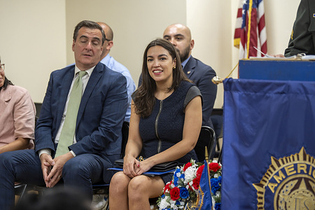 U.S. Representative Alexandria Ocasio-Cortez (C) attends the American Legion Boulevard Gardens Post 1836 2024 Memorial Day Ceremony in the Queens borough of New York City. Memorial Day is a federal holiday honoring military personnel who have died in performance of their military duties.