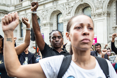Family members and friends of people who died while in police custody clench their fists during the demonstration. Protesters took part in the annual procession by the United Families and Friends Campaign where demonstrators marched from Trafalgar Square to Downing Street demanding Justice for victims of deaths while in police custody.