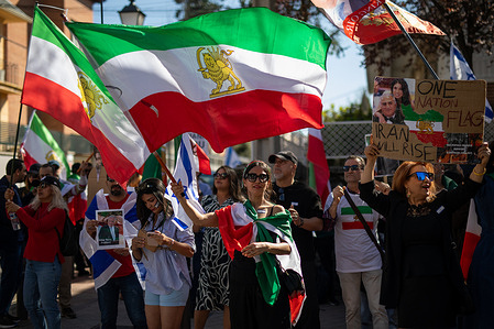 A woman carries an Iranian flag during a demonstration. Iranian residents gathered in front of the Iranian Embassy in Madrid on the eve of "Red Wednesday" (known as Chaharshanbe Suri in Persian culture or linked to the Newroz celebrations in Kurdistan), an ancient festival marking the last Wednesday before the spring equinox and the New Year (Nowruz).
They also demanded an end to the theocratic regime of the Ayatollahs and expressed their support for the military incursions against their country by the US and Israel.