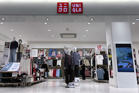 Shoppers seen checking out clothing at a Uniqlo store in Shinjuku as its parent company Fast Retailing accelerates global expansion and strengthens its digital and supply chain strategies to meet rising demand for affordable apparel.