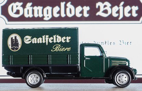 In this photo illustration, a model of a beer truck with the inscription "Gangelder Bejer" and the company logo in the background on the monitor screen. This beer has been produced since 2014 at a brewery in the town of Gangelt in North Rhine-Westphalia, Germany.