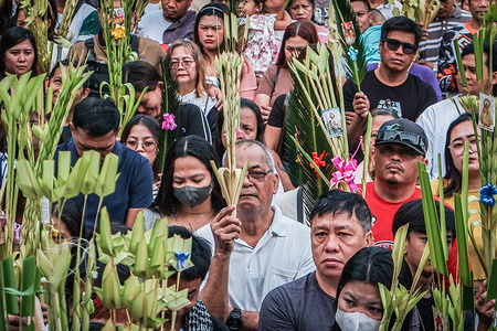 Catholic devotees attend Palm Sunday mass in Antipolo City. The rituals, which signify the start of Holy Week, re-enact the arrival of Jesus in Jerusalem. In Philippine culture, the blessed palms are kept as symbols of protection and victory.