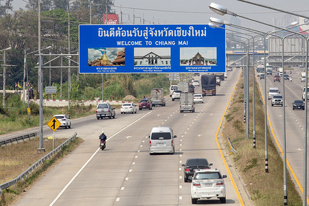 Vehicles travel along the Chiang Mai–Lampang Road beneath a “Welcome to Chiang Mai” sign. Hazy conditions from PM2.5 air pollution continue to affect the northern Thai city as air quality levels remain at unhealthy levels.
