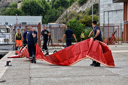 Men from the Bataillon des Marins-Pompiers de Marseille (BMPM) will set up a floating barrier to prevent the dispersion of hydrocarbons during a depollution operation. Following a fire that affected eleven boats moored in the port of L'Estaque in Marseille, men from the Bataillon des Marins-Pompiers de Marseille (BMPM) set up pollution control measures to prevent any leaks and dispersion of hydrocarbons.