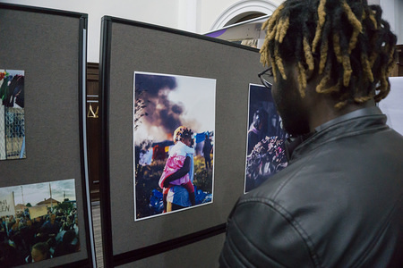 A young man watches few pictures during an event at Northampton University. The Refugee talks were organised by Changemaker Hub's Changing Futures Week, Northampton STAR (Student Action for Refugees) and University of Sanctuary.