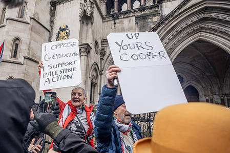 Pro-Palestinian activists hold placards expressing their opinion during the demonstration. Many pro-Palestinian activists celebrated outside The Royal Courts of Justice as the High Court ruled that the proscription of Palestine Action as a terrorist group was unlawful. Sitting with cardboard signs in support of Palestine Action, they were not arrested by awaiting Police on this occasion. The Government intends to appeal this decision.