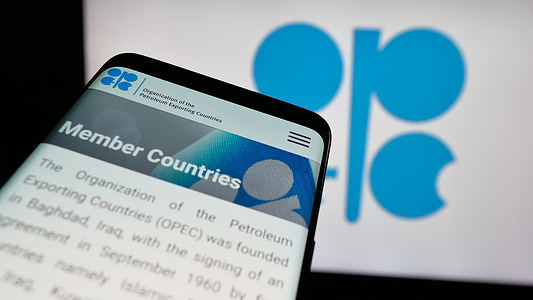 In this photo illustration, a mobile phone with the website of petroleum exporting organization OPEC is seen on screen in front of logo.