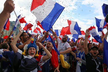 French football fans seen celebrating with their national flags.
French football fans celebrate their national football team victory over uruguay during the quarterfinal match of the Russia 2018 world cup finals.