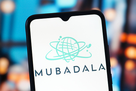 In this photo illustration, the Mubadala Investment Company logo is seen displayed on a smartphone screen.