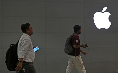 People seen walking near the Apple logo displayed outside the Apple store at Bandra Kurla Complex (BKC). Customers queued up outside the store from early morning in craze to buy the newly launched iPhone 18 Pro and iPhone 18 Pro Max model which went on sale in the Apple store at Bandra Kurla Complex (BKC) triggering a wave of excitement among the technology enthusiast across the country.