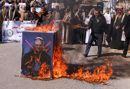 Palestinian protesters burn posters of Israeli Minister of National Security Itamar Ben Gvir in Gaza City during a demonstration in solidarity with Palestinian prisoners inside Israeli prisons. Protesters gather to demonstrate against the Israeli leaders and show solidarity with the Palestinian prisoners held captive in Israeli prisons. Since Prime Minister Benjamin Netanyahu sits in the Israeli government, Security Minister Itamar Ben-Gvir pledged to make the Palestinian inmates uncomfortable and not get better conditions in prison. Hence, he ordered to halt of the benefits and indulgences of the Palestinian security prisoners.