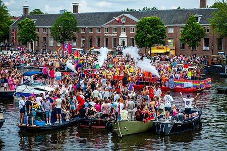People are watching the parade standing on boats. The Canal Parade is what Amsterdam Gay Pride is famous for. It's the crown of their two-week-long festival that features more than 200 events.