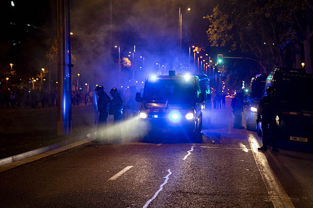 Riot police vans seen surrounded by smoke from burning containers. A demonstration held in connection with the general strike called in support of Palestine ended with serious riots in front of the Israeli consulate. Protesters burned containers, threw stones, and police responded with heavy charges and pepper spray.