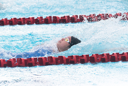 Levenia Entong Sim from Singapore seen in action during the women's 100m Backstroke preliminary round for the swimming event of the 33rd SEA Games at the Huamark Aquatic Center.