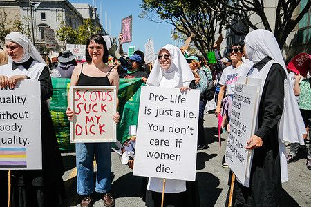 Protesters hold placards expressing their opinions during the "Women's March" for reproductive justice. Abortion-rights protesters participate in the "Women's March" on the streets of San Francisco.