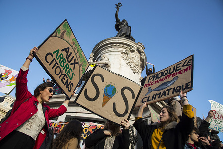 Protesters seen holding several placards around the Place de la Republique Monument during the March of The Century strike in Paris. Thousands of people demonstrated in the streets of Paris to denounce the inaction of the government about the climate change during a march called 'March of The Century' (La Marche du Siecle).