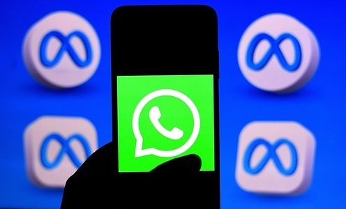 In this photo illustration, a Whatsapp logo seen displayed on a smartphone with metaverse logos in background.