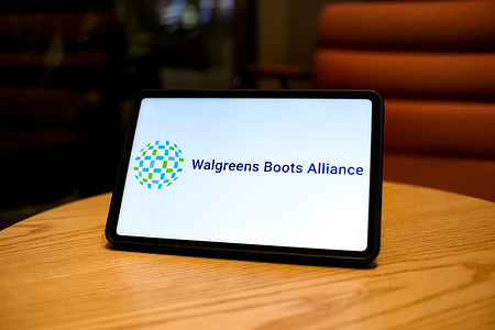 In this photo illustration, the Walgreens Boots Alliance logo is displayed on a tablet screen.