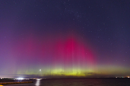 The Aurora Australis illuminates the sky from Brighton beach in Melbourne.