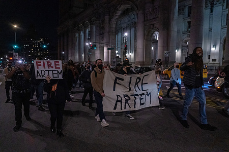 Protestors holding a placard and a banner that reads "FIRE ARTEM" march by City Hall during a demonstration to abolish the police and fire New York Police Department (NYPD) Officer, Prusayev.
According to protestors, on the evening of Tuesday, January 12, 2021 NYPD Officer Artem Prusayev pulled out his gun in the direction of protestors after being questioned why he wasn’t wearing a mask during that very demonstration.
