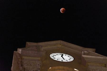 A total moon eclipse is seen rising in Firmat.