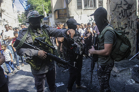 Masked Palestinian gunmen seen in the street of Nour Shams refugee camp in the northern West Bank. Palestinian Ministry of Health says one Palestinian man was killed in the West Bank refugee camp.