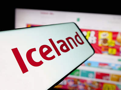 In this photo illustration, a smartphone with the logo of British retail company Iceland Foods Ltd. is seen on screen in front of website.