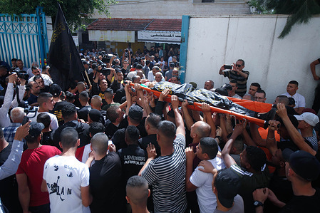 (EDITOR'S NOTE; Image depicts death)
Mourners and gunmen from the Islamic Jihad movement carry the body of the 17-year-old Palestinian, Amjad Al-Fayed, who was shot dead by the Israeli army during a raid on the Jenin refugee camp near the city of Jenin in the occupied West Bank.