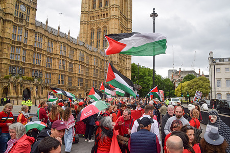 Protesters hold Palestinian flags outside the Houses of Parliament during a pro-Palestine demonstration. Pro-Palestinian demonstrators staged a protest demanding an arms embargo on Israel, that aid is delivered for the starving population in Gaza, and that Israel stops its attacks.