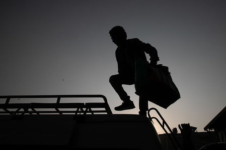 A silhouette of a man loading luggage onto a long distance bus leaving Kathmandu amid Coronavirus threats.
Nepalese government decided to close down public places such as schools, movie theatres, night clubs, Health clubs, cultural centres and Sports zone, from 19 March to 30 April 2020 as part of precautionary measures against the spread of the corona virus Covid-19.