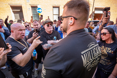 Tommy Joyce remonstrates with Mulligans staff at pub entrance. Organisers Tommy Joyce and John Reilly lead members of the Irish travelling community held a peaceful protest outside Mulligans pub in central Manchester. The demonstration follows an incident on Friday, April 17, 2026, where three members of the community were allegedly refused entry to the premises. Protesters marched with a pony and trap from St Peter's Square to Southgate, carrying banners and demanding an end to discrimination against Travelers in licensed establishments.