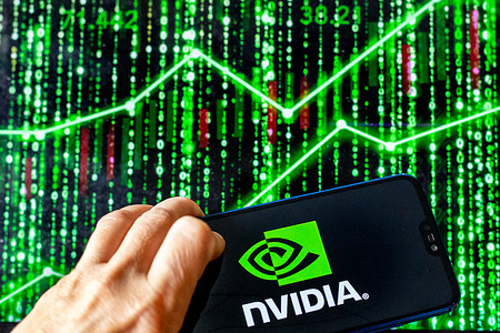 In this photo illustration, a Nvidia logo is seen displayed on a smartphone screen against a computer screen displaying a matrix image, as the company hits market capitalisation of $4 trillion.