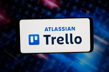 In this photo illustration, the logo of list-making software company Trello is displayed on a smartphone in front of abstract background on computer screen.