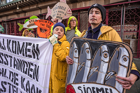 Ocean Rebellion protesters hold fish cut-out placards and a banner expressing their opinions during the 'World Fisheries Day' demonstration. Demonstrators from Ocean Rebellion staged a peaceful protest outside the Ministries of Agriculture, Nature and Food Quality this afternoon; this was in collaboration with OCEANA. Actions also took place in London and Brussels. Ocean Rebellion believe that the fishing quota should be reduced by 80 percent and, only local fishing communities that are dependent on a sea-catch should be granted fishing permits. Interworlds, industrial fishing is to stop. Ocean Rebellion says: 'Not enough control is placed on the Port of Rotterdam which has no check on illegally caught fish that enters the Netherlands, and this only encourages overfishing'. They go on to say: Do not remain blind to the many reports from the UN, EU committees and stop ignoring ICES science-based advice. The legal one obligation to stop overfishing by 2020 at the latest has been flouted.
