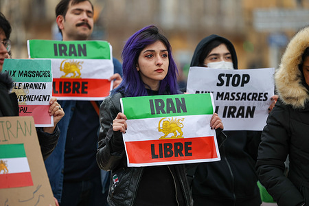Protesters hold flags and placards during a rally in support of the Iranian people. Around one hundred people gathered in the city center of Aix-en-Provence, France, to denounce the violence in Iran and express their support for the Iranian people.