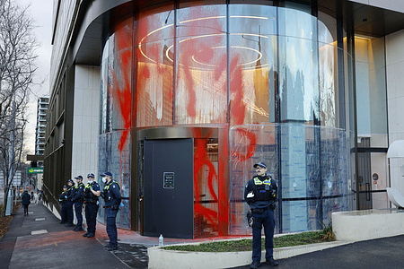 Red paint is seen splashed on the Toll Holdings building as police guard the entrance. Protesters held a snap rally outside Toll Holdings’ building headquarter in Melbourne, alleging the company’s connections to weapons suppliers. Demonstrators called on the logistics firm to cease all ties with military contractors, accusing it of contributing to violence and conflict in Australia and overseas. The protest was held to denounce Toll’s alleged role in facilitating arms transport linked to global and colonial violence.
