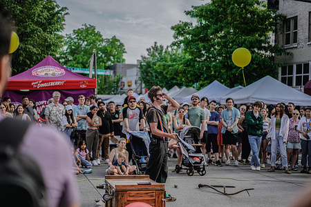 A street performer captivating a crowd with their mesmerizing juggling skills at the U District Street Fair. The U District Street Fair held its 51st year at the heart of the University District in Seattle which was held on May 20 and 21. The streets were transformed into a marketplace filled with creativity, entertainment, and delicious food.