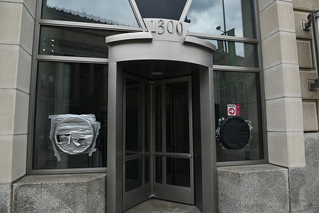 The former entrance to the US Agency for International Development (USAID). The agency was eliminated under orders from US President Donald Trump and tech CEO Elon Musk's Department of Government Efficiency (DOGE) following conspiracy theories. Seals from USAID on the front windows remain covered with duct tape.