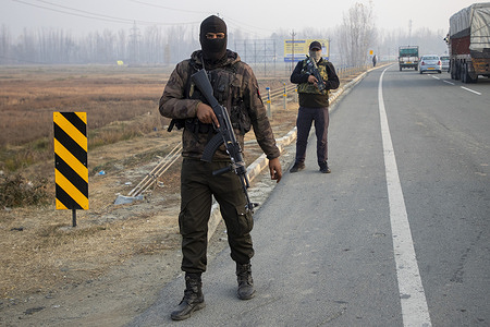 Special Operations Group personnel of Jammu and Kashmir police stand alert along Srinagar-Jammu National Highway during a cordon and search operation following a deadly car blast in Delhi that killed 13 people and injured dozens.
