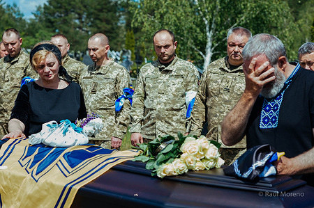 The soldier's parents and Ukrainian soldiers pay their last respect during the funeral ceremony. Military funeral for Alexander Kuchenerenko, 28years old. Engineer of the Armed Forces of Ukraine was killed in an ambush in Bakhmut. The village of Ivankiv bids farewell to the dead soldier with honour.