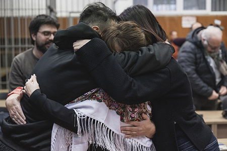 Maysoon Majidi (C) seen hugging her brother Rajan (L) and a friend (R) after the verdict. The Kurdish-Iranian film director and activist Maysoon Majidi arrived on a boat in Italy on 31.12.2023 and was acquitted of charges of favoring illegal immigration and smuggling by the court of Crotone.