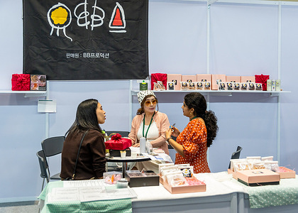 Asian nationalities seen at a booth at Seoul Food held at the Queen Sirikit National Convention Center. Seoul Food is a trade and business only exhibition that showcases Korea's tastes and trends, aiming to connect Korean brands with the ASEAN market, offering opportunities for business growth, collaboration, and cultural exchange.